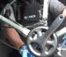 Cytech-trained Domex Bikes mechanic using a chain checker tool to measure wear on a bike cassette